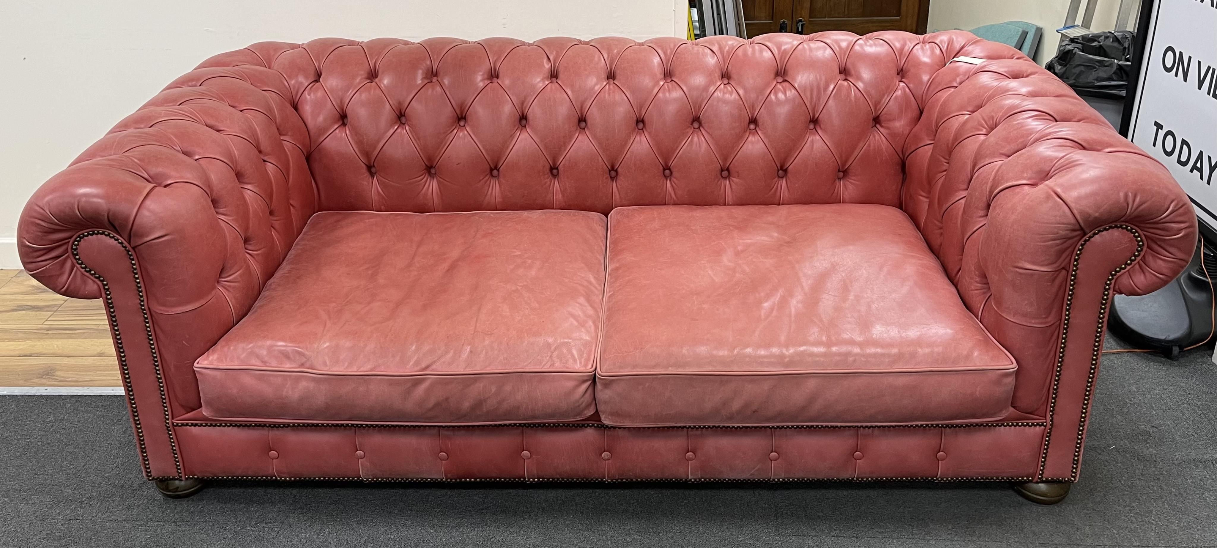 A Victorian style buttoned pale red leather Chesterfield settee, width 210cm, depth 104cm, height 71cm. Condition - fair to good